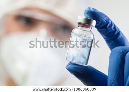 Cell division process conceptual illustration,lab scientist holding ampoule vial with cell nucleus molecules splitting,DNA replication procedure,mitosis daughter from parent chromosome cell production Royalty-Free Stock Photo #1886868589