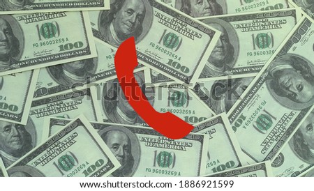 The handset is red against the background of American dollar bills. Negotiations with financial partners.