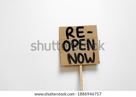 'Reopen now' placard for protest close up