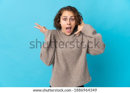Young English woman isolated on blue background making phone gesture and doubting