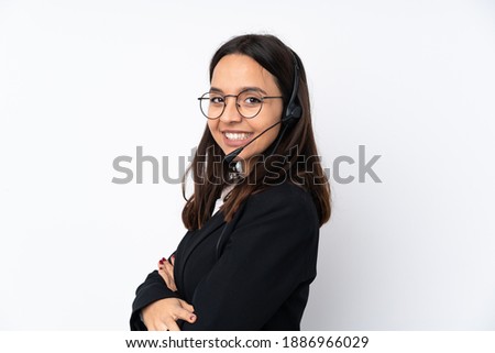Young telemarketer woman isolated on white background with arms crossed and looking forward