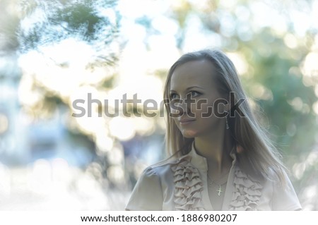 portrait of 30 year old blonde woman in park