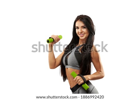 Isolated portrait of a sporty young fitness woman with dumbbells on a white background