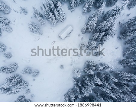 Cold winter morning in mountain foresty with snow covered fir trees. tatras, slovakia. Aerial view. Cabin alone in snow forest