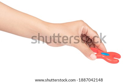 hand holding plastic adjustable spanner toy isolated on white background