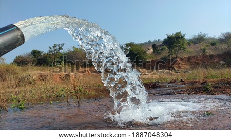village farming bore water and village cheruv , river water water slow motion pictures, pump water slow motion pictures, dry grass  