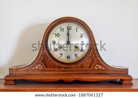 Close up of an antique clock showing 12 oclock Royalty-Free Stock Photo #1887061327
