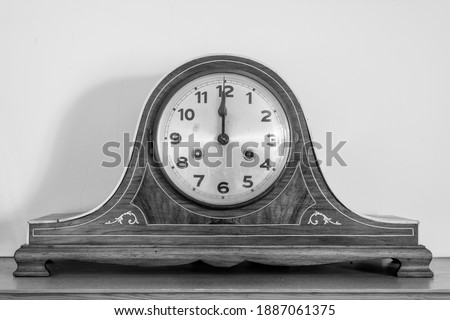 Black and white photo of an antique clock showing 12 oclock Royalty-Free Stock Photo #1887061375