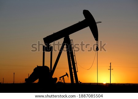 Pumpjacks, the sunset of New Mexico oil field, shot near Carlsbad. Royalty-Free Stock Photo #1887085504