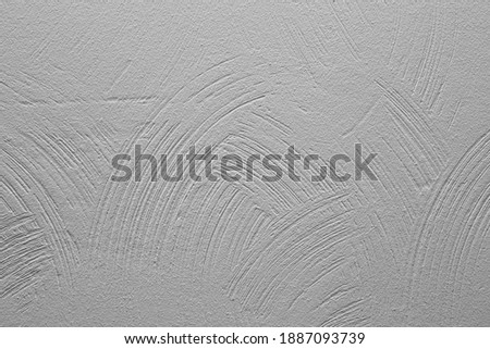 Decorative plaster. Wall with rounded stripes of applied plaster, painted in gray. Background for text.