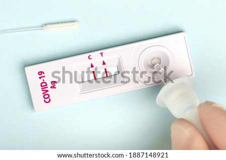 Man makes a covid-19 antigen pcr express test macro. The test showed a positive result Royalty-Free Stock Photo #1887148921