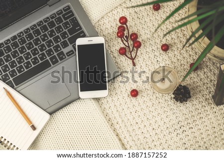 Winter, autumn workspace composition, mock-up flat lay design with background of knitted sweaters, decoration, smartphone concept, copy space, for bloggers photo
