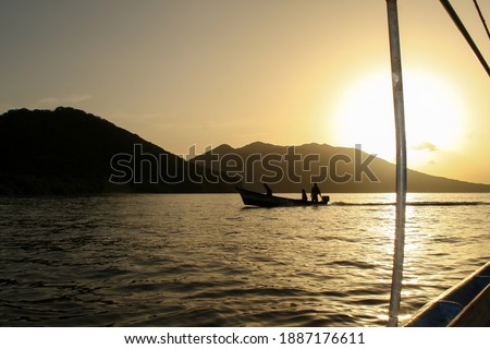 Silhouette  of a boat with fishermen coming back from a work day