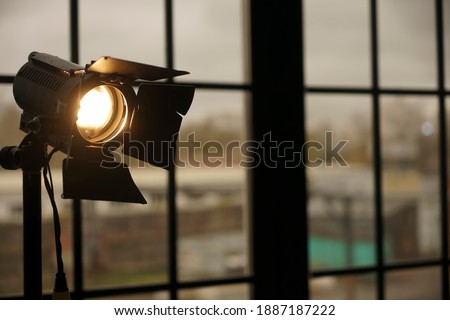 Photography studio on window background with lamp. Professional lighting equipment for video production. constant light