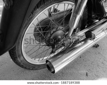 
Muffler and wheels are part of the motor bike at the rear of the motorcycle.