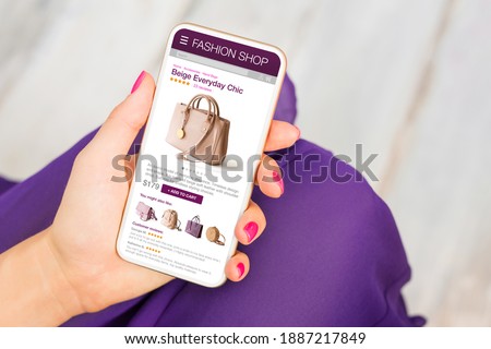 Woman shopping for a new bag in online store on her phone