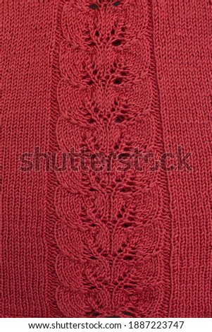 Red knitted cotton fabric, hand knit, plain knitting,  branch in  knitting needles.