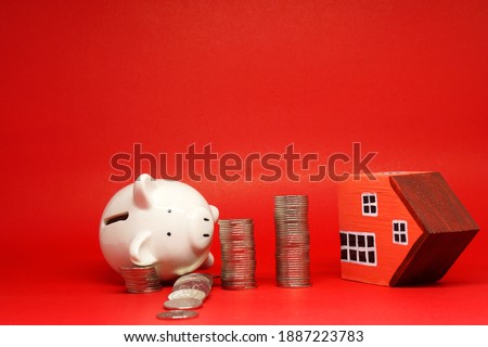 Domino Effect of Fail Fund , Investment , Saving money concept : White Piggy bank coin and House on red background with copy space for text messag - Banking and finance , loan and loss benefit concept