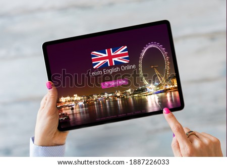 Person taking online courses on tablet to learn English