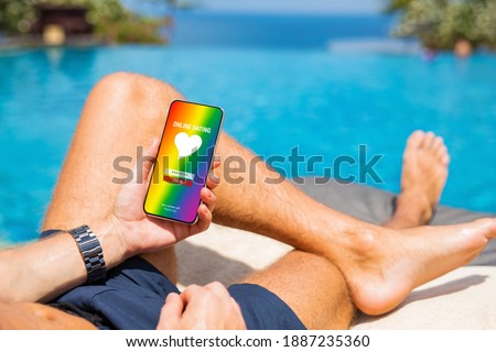 Man using gay and LGBT dating app on his mobile phone