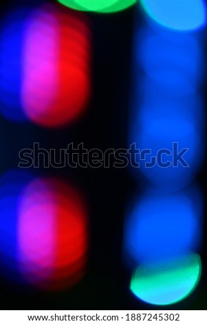 Multi-colored gradient circles on a dark background. Abstract blurred background. Vertical photo