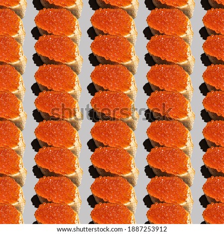 Seamless pattern with red caviar sandwich on gray background.