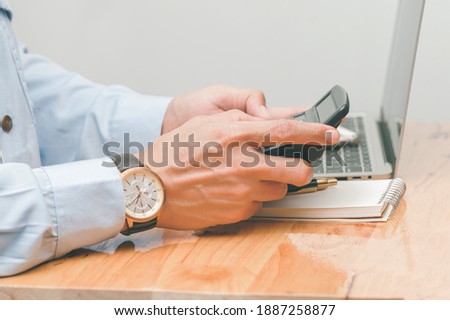 male accountant making calculations,reviewing data in financial charts and graphs  at work place. Business financial  concept.