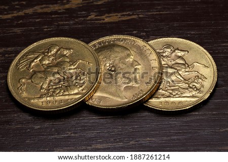 British full Sovereign gold coins (Edward VII) on wooden background