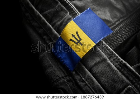 Tag on dark clothing in the form of the flag of the Barbados