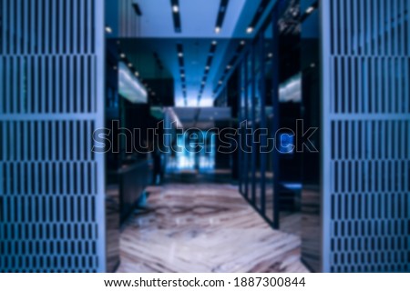 Shot of Modern Data Center With Multiple Rows of Fully Operational Server Racks. blurred background