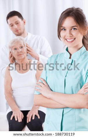 Elderly woman having neck adjustments in clinic