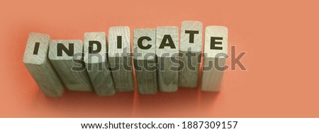 Indicate word on wooden blocks on cyan background. Financial indicator Unsecured and secured bonds or KPI concept.