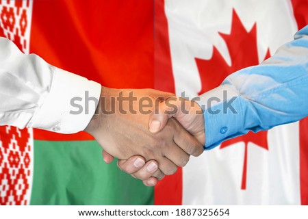 Business handshake on the background of two flags. Men handshake on the background of the Belarus and Canada flag. Support concept