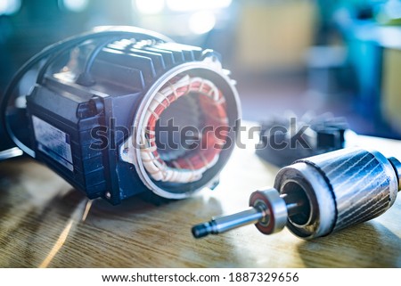 Close-up of an iron industrial motor lies on a table during the production of new modern trucks in a factory. The concept of reliable and high-quality special cars Royalty-Free Stock Photo #1887329656