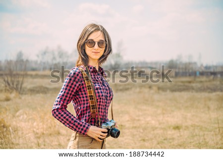 Hipster happy girl with vintage photo camera outdoor