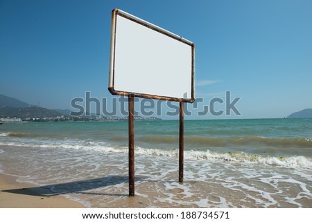 Blank sign against beautiful blue ocean