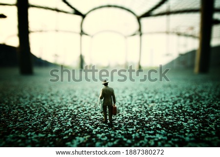 Surreal image of mysterious man walking alone in urban environment