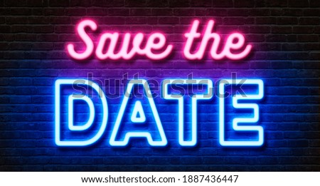 Neon sign on a brick wall - Save the date
