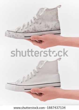 White canvas sneakers before and after cleaning comparison. Hand holding the same shoe, dirty and fresh. Royalty-Free Stock Photo #1887437134