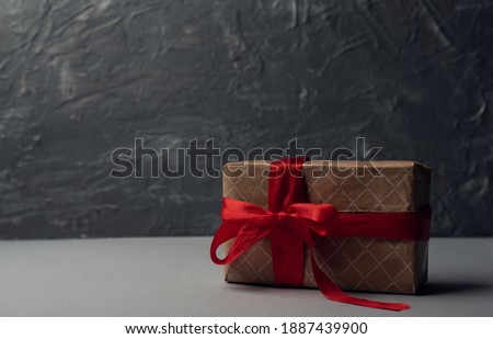 Gift box with red ribbon on light background. A gift for Valentine's Day. Space for text.