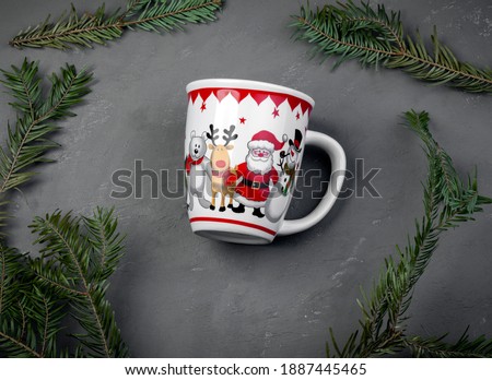 White cup with the image of a deer, santa on a gray background among the fir branches