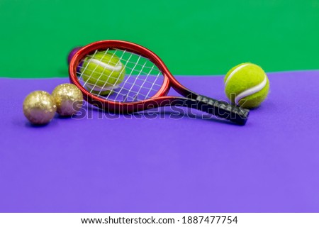 Tennis racket with  balls are on green and purple background