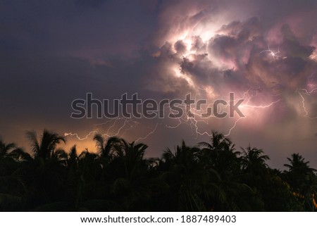 dramatic thunder bolts emerging from the sky on a rainy day in India. 