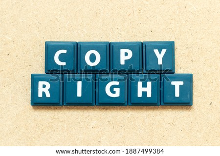 Tile alphabet letter in word copyright on wood background