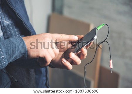 Man holds cellphone in hands, close up