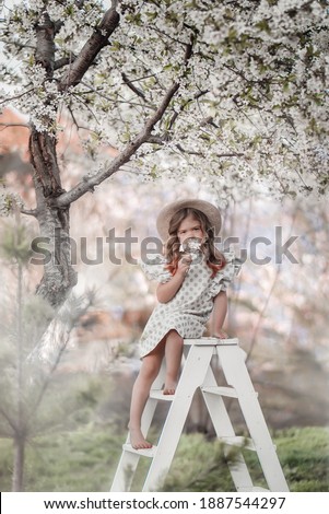 Little girls and blosson tree