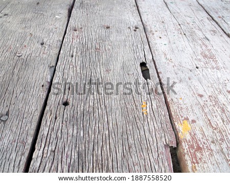 perspective of grunge hardwood pathway floor texture, old wooden walkway bridge or boardwalk that weathered with rough surface and cracked, close-up selective focus