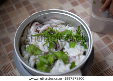 Cooking squids in pot steam in kitchen. Seafood menu. Selective focus. soft picture