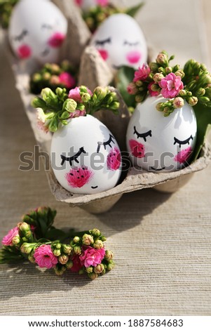 Easter card. Cute eggs with flowers and pink cheeks.Easter card