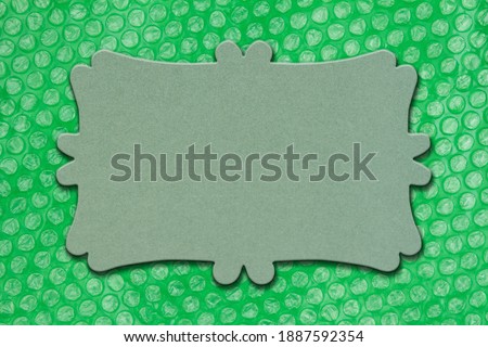 Blank green sign on green bubble wrap material mockup with copy space for your shipping or packaging message
